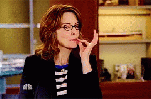 Woman in Glasses and Black Jacket With NBC Sleeve