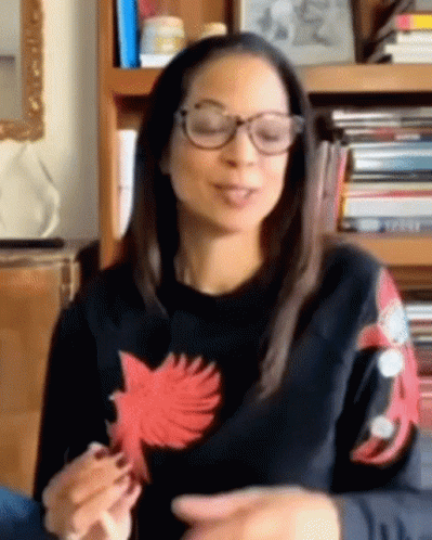 Woman in Glasses and Black Sweater With Red Bird Sleeves