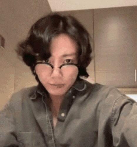 Woman in Glasses and Denim Shirt Taking Selfie