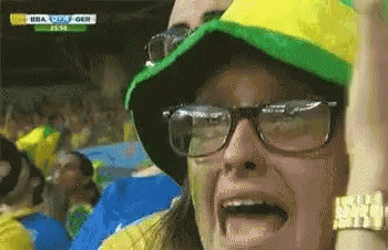 Woman in Glasses and Hat Watching Soccer Game