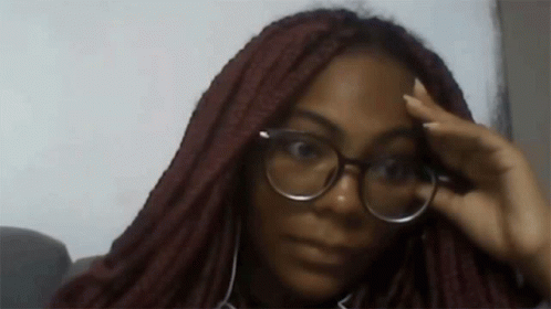 Woman in Glasses and Headphones Looking at Camera