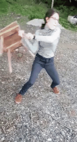 Woman in Glasses and Jeans Throwing Chair