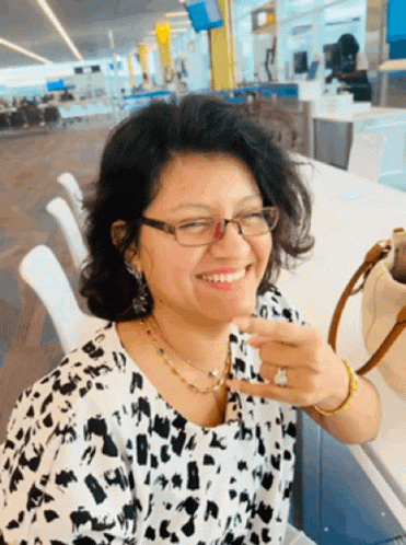 Woman in Glasses and Leopard Print Shirt Smiling