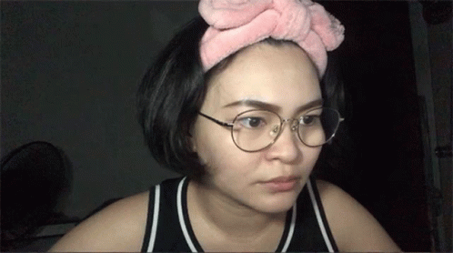 Woman In Glasses And Pink Headband Looking At Camera GIF