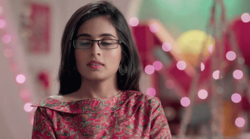 Woman in Glasses and Pink Shirt Looking Down