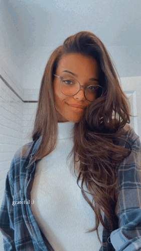 Woman in Glasses and Plaid Shirt Saying Grateful