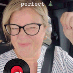 Woman in Glasses and Striped Shirt Holding Record Saying Perfect