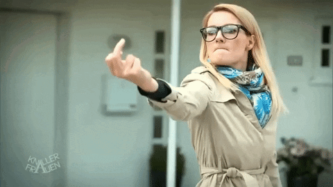 Woman in Glasses and Trench Coat Showing Middle Finger