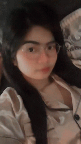 Woman in Glasses and White Shirt Looking at Camera