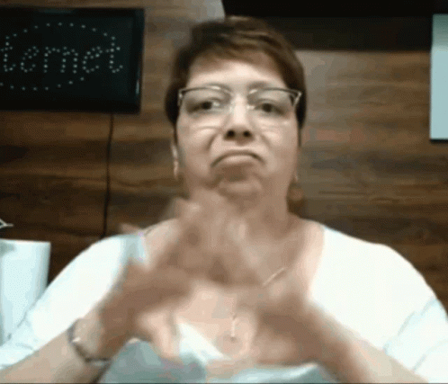 Woman In Glasses And White Shirt Making Funny Face GIF