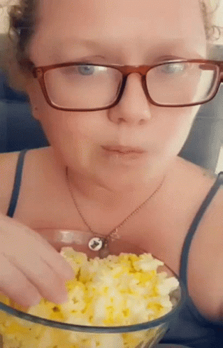 Woman in Glasses Eating Popcorn
