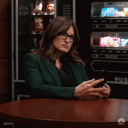 Woman in Glasses Looking at Phone