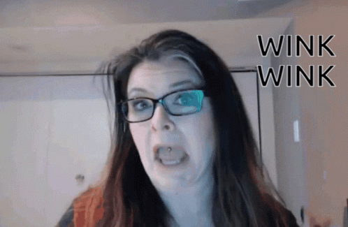 Woman in Glasses Making Funny Face Wink Wink