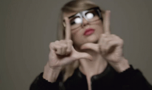 Woman in Glasses Making Heart Shape
