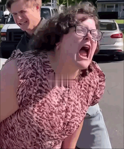 Woman in Glasses Screaming Man Holds Her Back