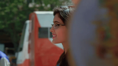 Woman in Glasses Smiling by Red and White Truck