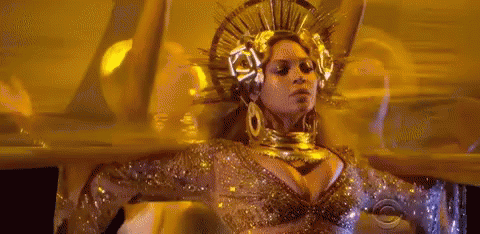 Woman in Gold Crown and Earrings Dancing