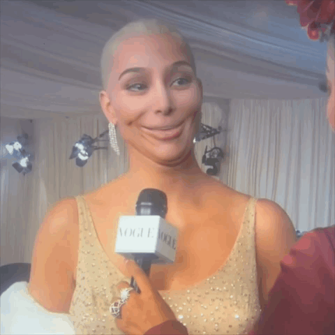 Woman in Gold Dress Being Interviewed
