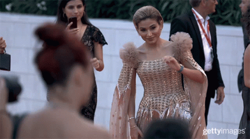 Woman In Gold Dress Photographed By Getty Photographer GIF