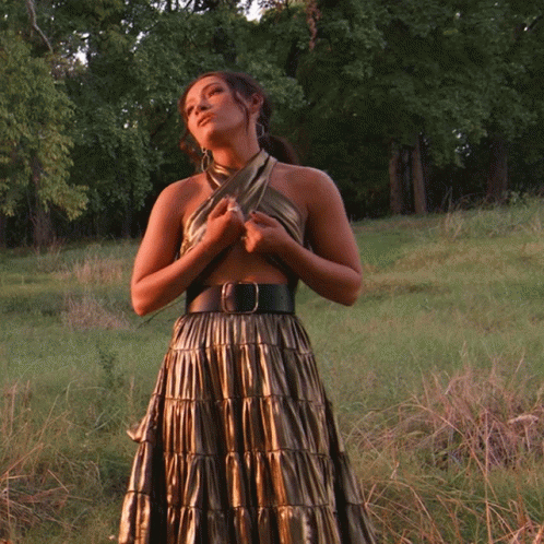 Woman in Gold Dress Standing in Field