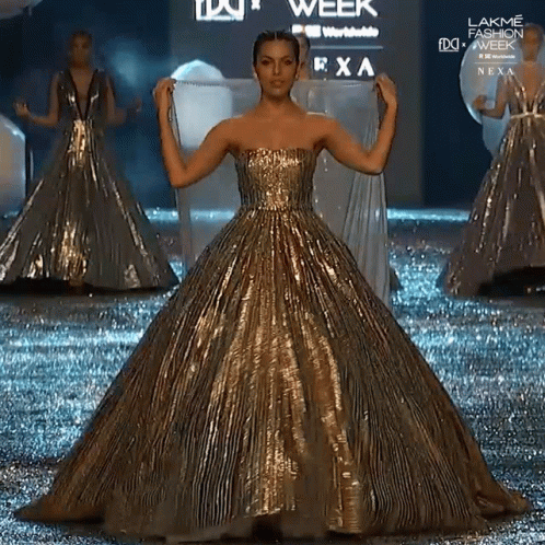 Woman in Gold Dress Walking at Lakme Fashion Week