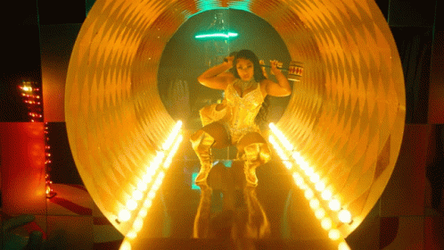 Woman in Gold Outfit in Tunnel With Lights