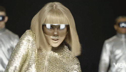 Woman in Gold Outfit with Mask and Sunglasses