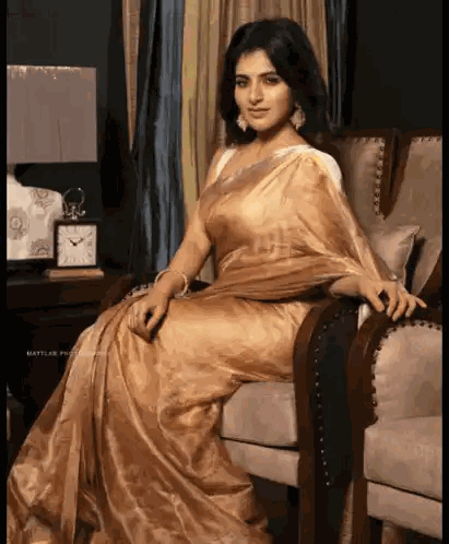 Woman in Gold Saree Sitting