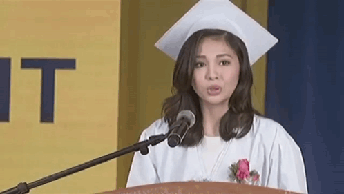Woman in Graduation Cap and Gown at Podium