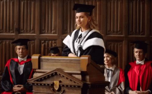 Woman In Graduation Cap And Gown Giving Speech GIF