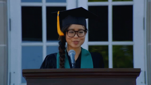 Woman In Graduation Cap And Gown Giving Speech GIF