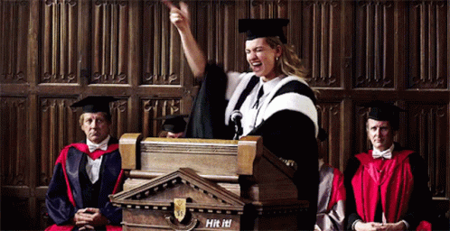 Woman In Graduation Cap And Gown Giving Speech GIF