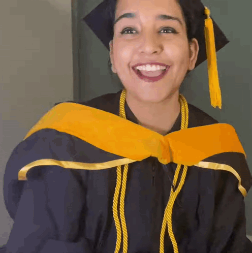 Woman In Graduation Cap And Gown Smiling GIF
