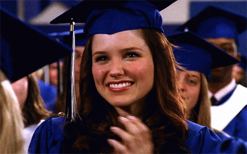 Woman in Graduation Cap and Gown Smiling