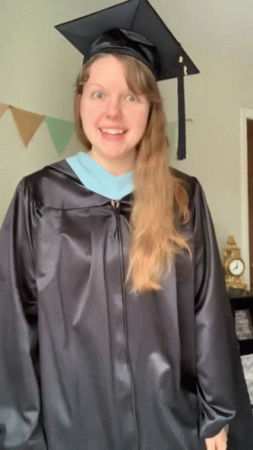 Woman In Graduation Cap And Gown Smiling GIF