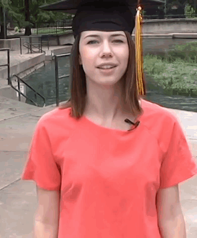 Woman in Graduation Cap and Gown Smiling