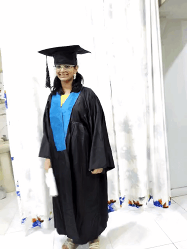 Woman In Graduation Cap And Gown Smiling GIF