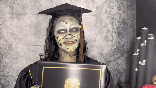 Woman In Graduation Cap And Gown With Zombie Makeup GIF