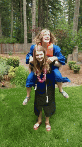 Woman in Graduation Gown Carrying Another Woman