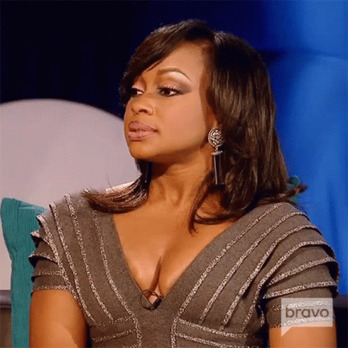 Woman In Gray Dress And Earrings Sitting On Couch Bravo TV GIF