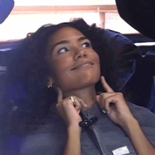 Woman In Gray Shirt With White Patch On Sleeve GIF