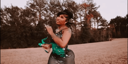 Woman In Green And Black Dress Dancing In Field GIF
