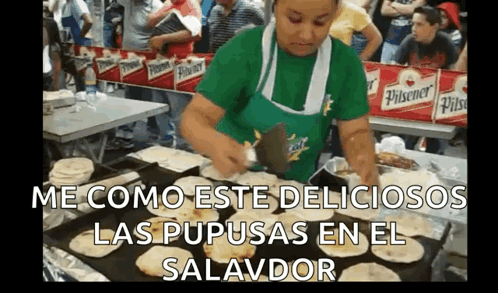 Woman in Green Apron Cooking Tortillas