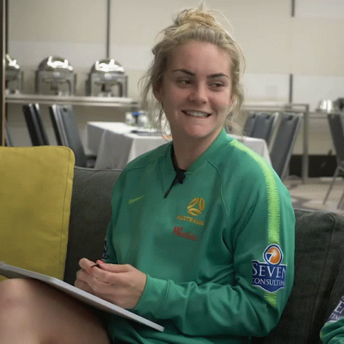 Woman in Green Australia Jacket on Couch