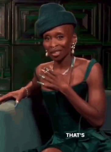 Woman in Green Dress and Green Hat on Couch