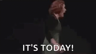 Woman in Green Dress Arms Outstretched Saying It's Today
