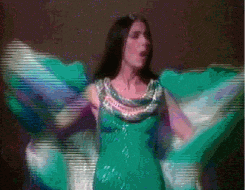 Woman in Green Dress Dancing with Wings Outstretched
