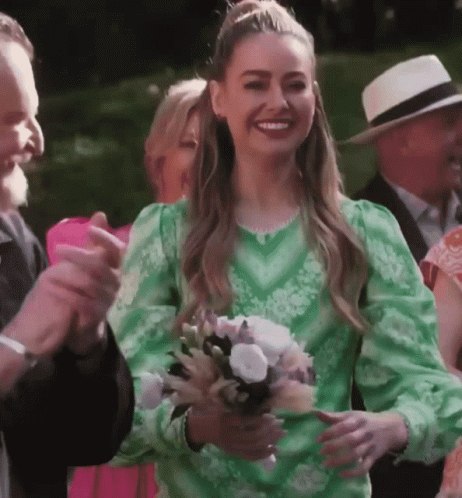 Woman in Green Dress Holding Flowers