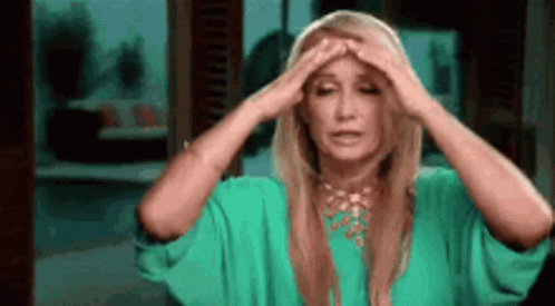 Woman In Green Dress Holding Head GIF