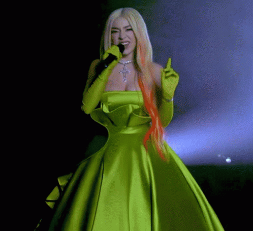 Woman in Green Dress Holding Microphone